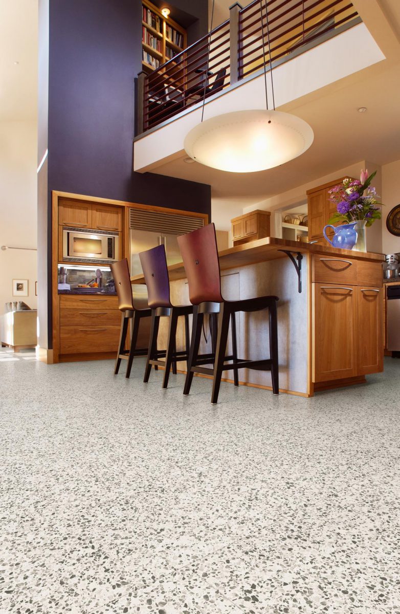 Chairs by kitchen island and hardwood flooring